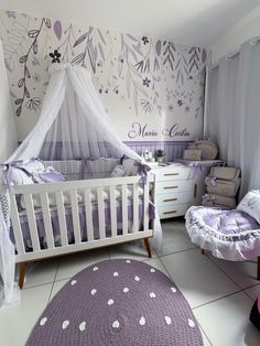 a baby's room with purple and white decor