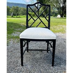 a black and white chair sitting on top of gravel