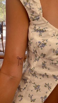 a woman with a small tattoo on her arm