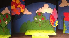 the stage is set up for children's play with trees and clouds painted on it