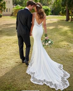 a bride and groom standing in the grass