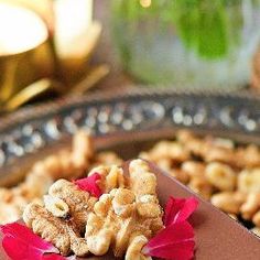 a table topped with lots of food on top of a metal tray covered in flowers