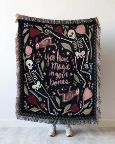 a blanket with skeletons and hearts on it that says you have magic in your bones