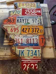 several license plates are stacked on top of each other in the shape of a map