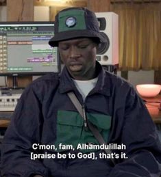 a man sitting in front of a computer monitor wearing a hat with the words c'mon, fam, alhamdullillah, praise be to god, that's it