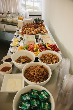 a woman standing in front of a buffet table filled with food