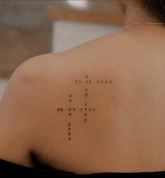 the back of a woman's shoulder with words written on it