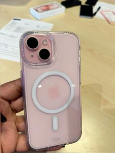 a person holding an iphone case with a magnifying glass on the back in front of them