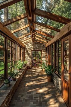 the inside of a building with lots of windows and plants in pots on either side