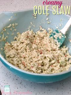 a blue bowl filled with coleslaw and sprinkles on top of a table