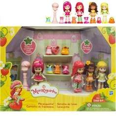 the strawberry shortcakes doll set is in its box with other dolls and accessories