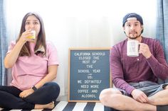 two people sitting on the floor drinking coffee