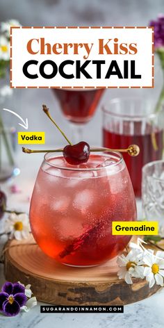 the cherry kiss cocktail is served in a glass with ice and garnishes