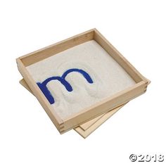 two coasters with the letter m in blue and white on them, sitting next to each other