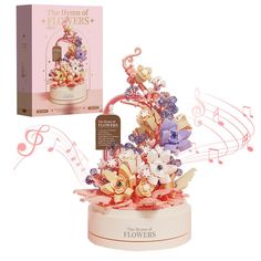 an arrangement of flowers and musical notes in a gift box