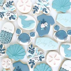 baby shower cookies decorated with blue and white icing are on display for the guests to enjoy