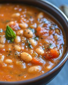 a close up of a bowl of soup with beans and carrots