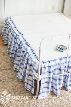 a bed with a blue and white checkered bedspread on top of it