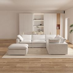 a large white couch sitting on top of a wooden floor