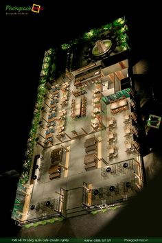 an aerial view of a restaurant at night with tables and chairs around the outside area