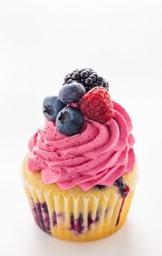 a cupcake with berries and blueberries on top