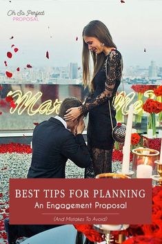 a man kneeling down next to a woman on top of a table with red flowers