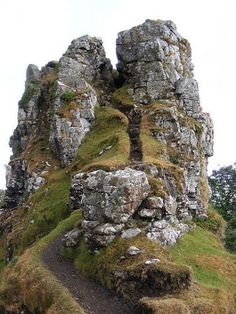 an old stone structure with moss growing on it