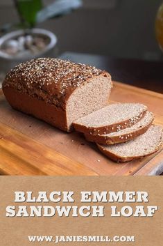 a loaf of black emmer sandwich loaf sitting on top of a cutting board