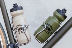 two water bottles attached to the handlebars of a bicycle