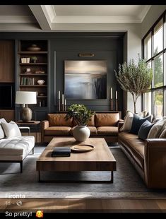 a living room filled with lots of furniture and large windows in the wall behind it