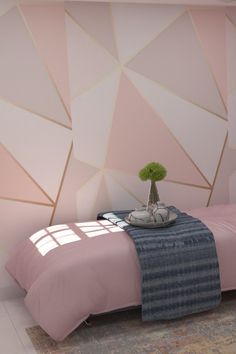 a bedroom with a pink bed and white walls, decorated with geometric shapes on the wall