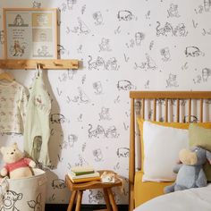 a child's bedroom with winnie the pooh wallpaper