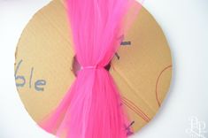 a paper plate with pink hair on it