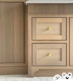 a cabinet with three drawers and two knobs