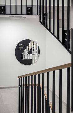 the number four sign is on the wall next to some black and white railings