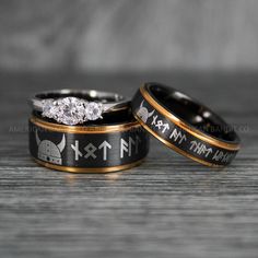 two wedding rings with the names of each couple engraved on them, sitting next to each other