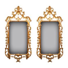 two gold framed mirrors sitting side by side on top of each other, one with an ornate