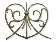 an iron heart shaped decoration on a white background