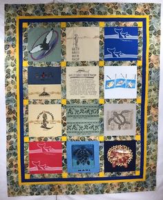 a quilt made to look like it has many different designs on it and is hanging up against the wall