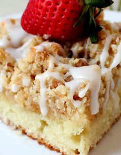 a close up of a piece of cake on a plate with a strawberry on top