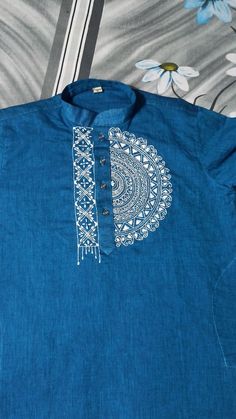 a blue shirt with white designs on it