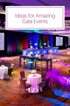 an event venue with tables and chairs set up in the center, surrounded by colorful lights