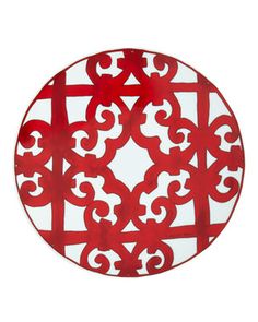 a red and white plate sitting on top of a metal stand in front of a gray background