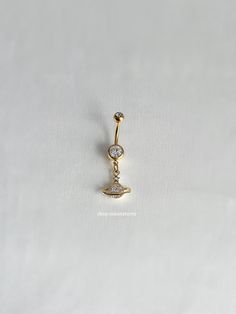 a gold nose ring with two diamonds on it's side, and a crescent in the middle