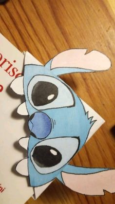 a close up of a piece of paper with a cartoon character on it's face