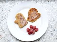 two pieces of toasted bread on a plate with grapes