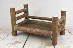 a small wooden chair sitting on top of a white floor