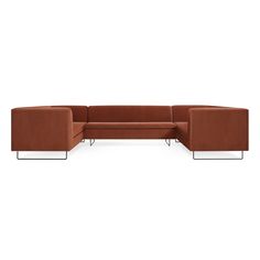 a brown sectional couch sitting on top of a white floor next to a metal frame