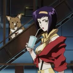 a woman holding a cup next to a dog