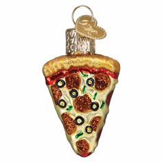 a glass ornament shaped like a slice of pizza with olives and pepperoni